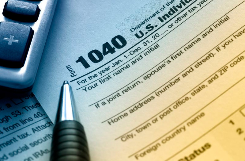 1040 Tax Form with pen and calculator